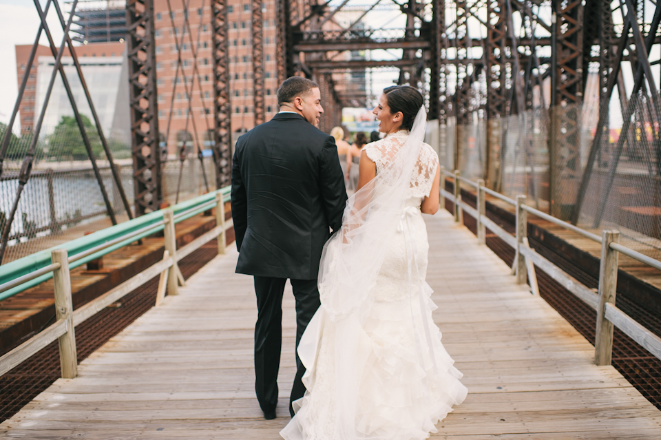 bride and groom on wrought iron bridge