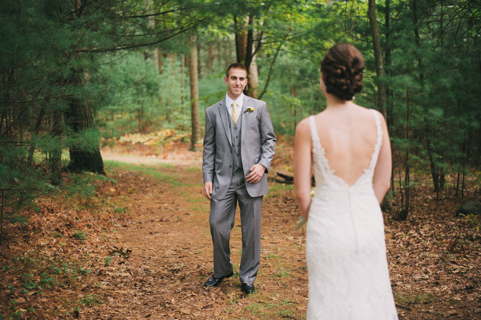 groom seeing bride for the first time in the woods