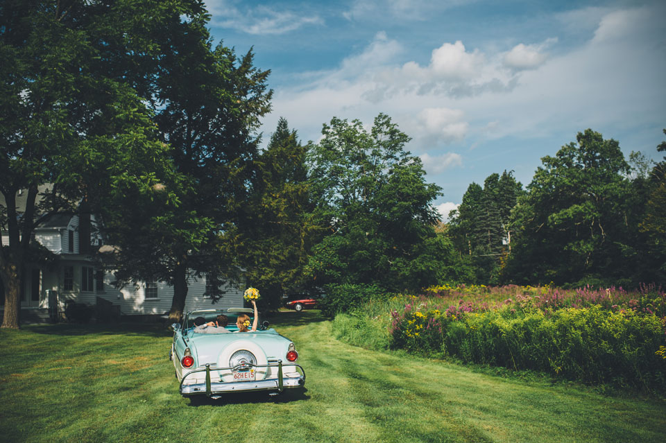 bride and groom in vintage car